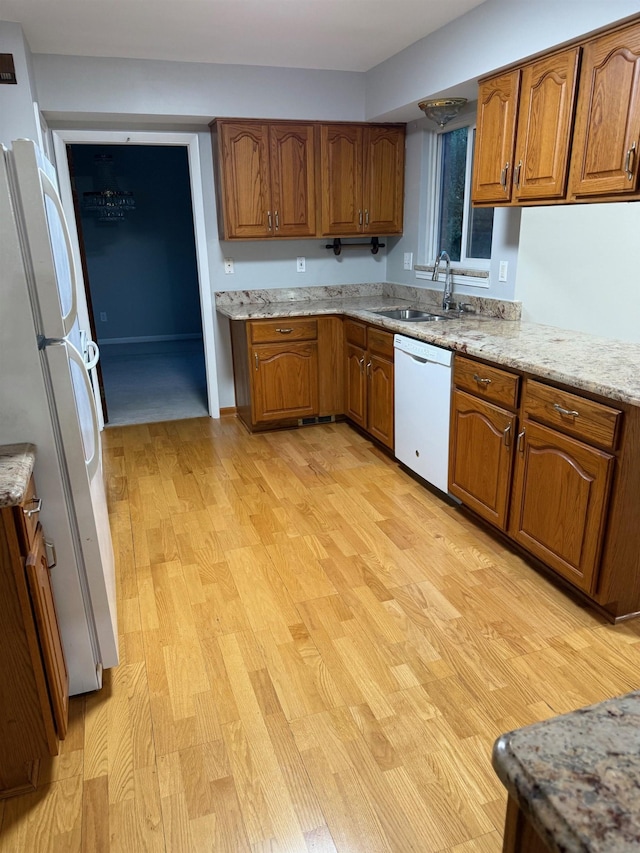 12806 Via Catherina Dr, Grand Blanc, MI 48439 - kitchen featuring white appliances, brown cabinets, light wood-type flooring, and light stone counters