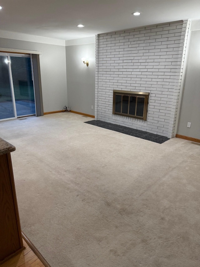 12806 Via Catherina Dr, Grand Blanc, MI 48439 - unfurnished living room with carpet, recessed lighting, and a brick fireplace