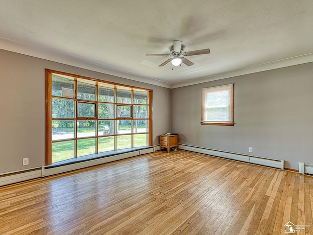 855 Mildred Ave, Temperance, MI 48182 - spare room featuring a baseboard radiator, light wood-type flooring, ceiling fan, and crown molding