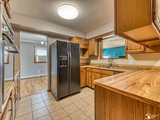 855 Mildred Ave, Temperance, MI 48182 - kitchen with black fridge with ice dispenser, butcher block counters, brown cabinets, light tile patterned flooring, and cooling unit
