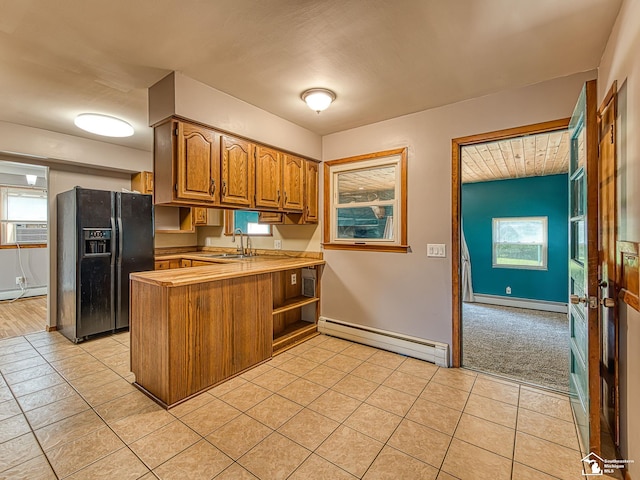 855 Mildred Ave, Temperance, MI 48182 - kitchen with a baseboard heating unit, black refrigerator with ice dispenser, a baseboard radiator, a peninsula, and light tile patterned flooring