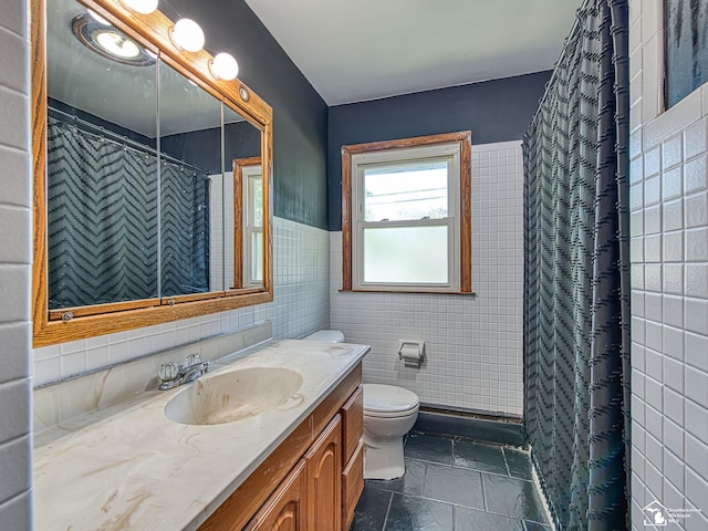 855 Mildred Ave, Temperance, MI 48182 - full bathroom with vanity, tile walls, a shower with curtain, stone tile flooring, and wainscoting