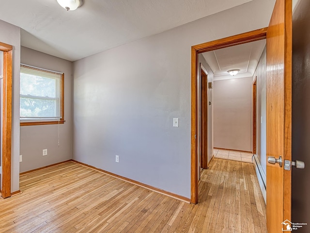 855 Mildred Ave, Temperance, MI 48182 - unfurnished room with light wood-style flooring and a baseboard radiator