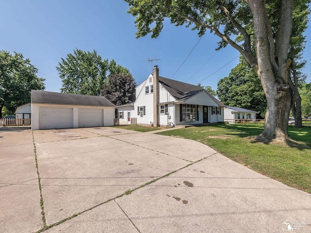 855 Mildred Ave, Temperance, MI 48182 - view of side of home featuring an outdoor structure, a garage, a lawn, covered porch, and a chimney