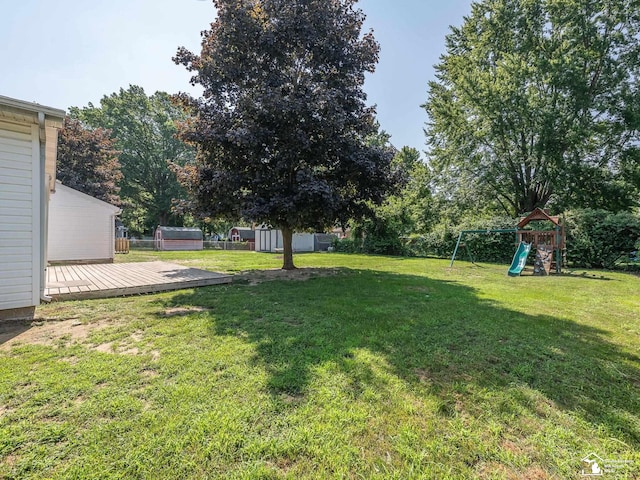 855 Mildred Ave, Temperance, MI 48182 - view of yard featuring a storage unit, a playground, and a deck
