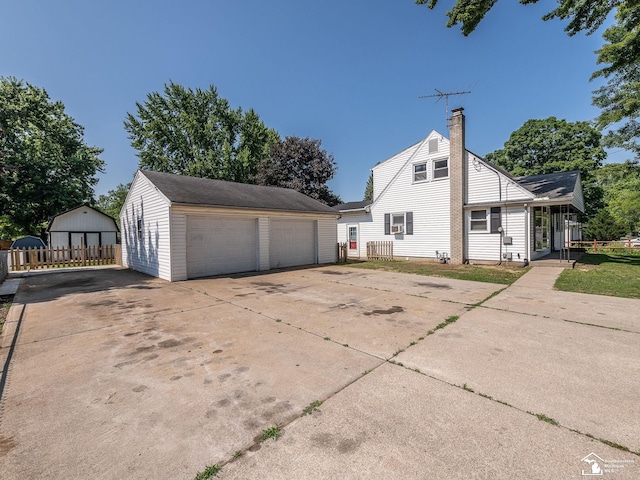 855 Mildred Ave, Temperance, MI 48182 - view of side of home featuring an outdoor structure, a detached garage, and a chimney