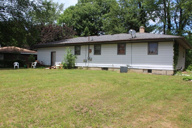 2582 Vista Lake Dr, Benton Harbor, MI 49022 - rear view of property with a chimney and a lawn