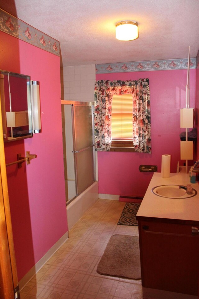 2582 Vista Lake Dr, Benton Harbor, MI 49022 - bathroom featuring vanity, combined bath / shower with glass door, tile patterned floors, and baseboard heating