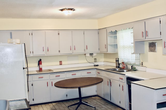 2582 Vista Lake Dr, Benton Harbor, MI 49022 - kitchen with freestanding refrigerator, open shelves, light countertops, and light floors
