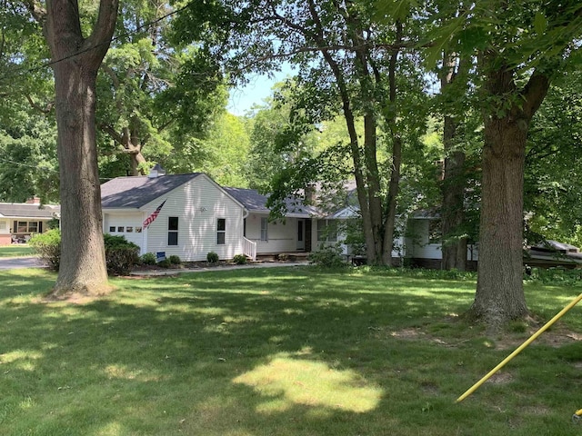 4442 Congdon Dr, Williamston, MI 48895 - view of front of property featuring a garage and a front yard