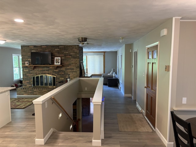 4442 Congdon Dr, Williamston, MI 48895 - hall featuring wood finished floors, an upstairs landing, and recessed lighting