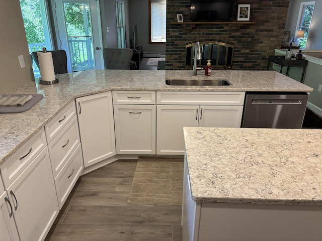 4442 Congdon Dr, Williamston, MI 48895 - kitchen with stainless steel dishwasher, dark wood finished floors, white cabinetry, and light stone counters