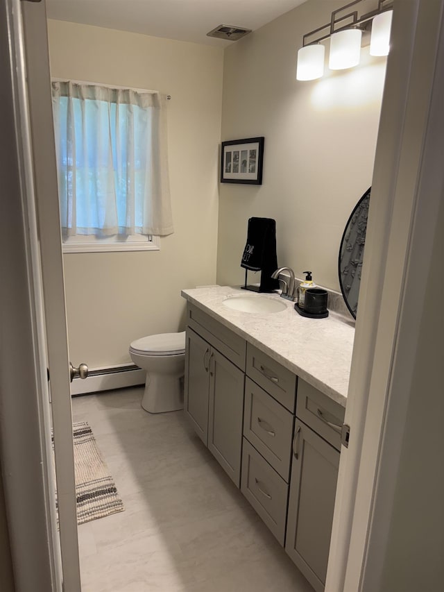 4442 Congdon Dr, Williamston, MI 48895 - bathroom featuring a baseboard heating unit and vanity