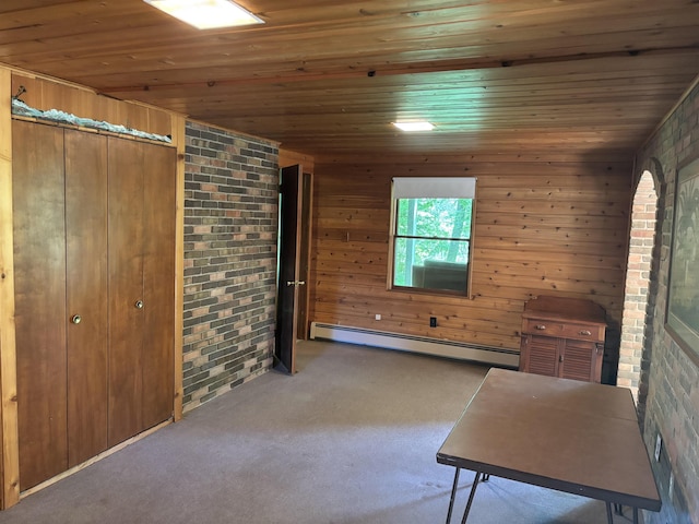 4442 Congdon Dr, Williamston, MI 48895 - bedroom featuring baseboard heating, wooden ceiling, brick wall, carpet floors, and wooden walls