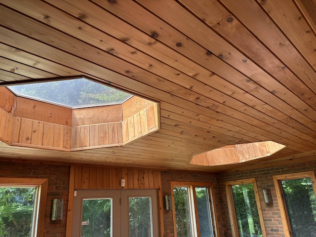 4442 Congdon Dr, Williamston, MI 48895 - detailed view of wooden ceiling, a skylight, and brick wall