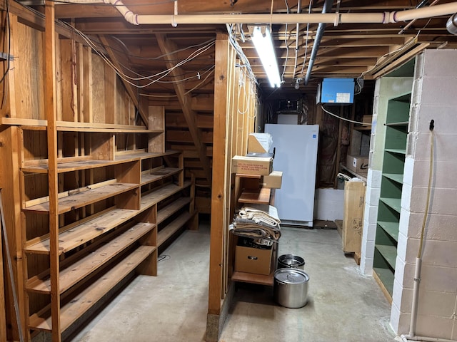 4442 Congdon Dr, Williamston, MI 48895 - unfinished below grade area with freestanding refrigerator