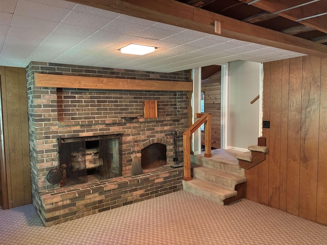 4442 Congdon Dr, Williamston, MI 48895 - finished basement featuring carpet flooring, a fireplace, stairs, and wood walls