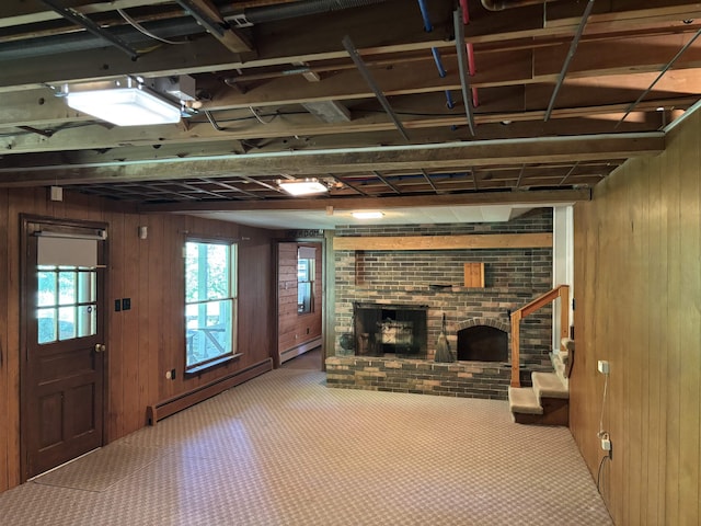 4442 Congdon Dr, Williamston, MI 48895 - below grade area with wood walls, brick wall, a baseboard heating unit, a fireplace, and carpet