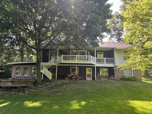 4442 Congdon Dr, Williamston, MI 48895 - back of property featuring a wooden deck, a lawn, stairs, and brick siding