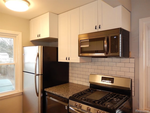 3161 Fort Park Blvd, Lincoln Park, MI 48146 - kitchen with stainless steel appliances, tasteful backsplash, and white cabinets