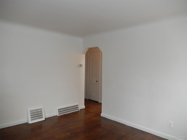 3161 Fort Park Blvd, Lincoln Park, MI 48146 - unfurnished room with arched walkways and dark wood-style floors