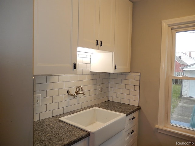 3161 Fort Park Blvd, Lincoln Park, MI 48146 - kitchen featuring white cabinets, tasteful backsplash, and dark stone counters