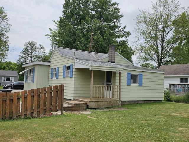 109 W Woodrow St, Fremont, MI 49412 - rear view of property featuring a chimney