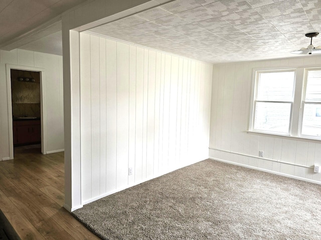 109 W Woodrow St, Fremont, MI 49412 - spare room featuring wood walls and wood finished floors