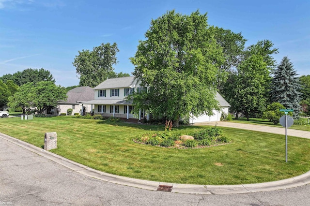 5130 Highpoint Dr, Swartz Creek, MI 48473 - view of front facade with curved driveway, a front yard, covered porch, and an attached garage