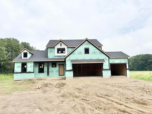 9520 Alaska Ave SE, Alto, MI 49302 - property under construction with dirt driveway, an attached garage, and roof with shingles