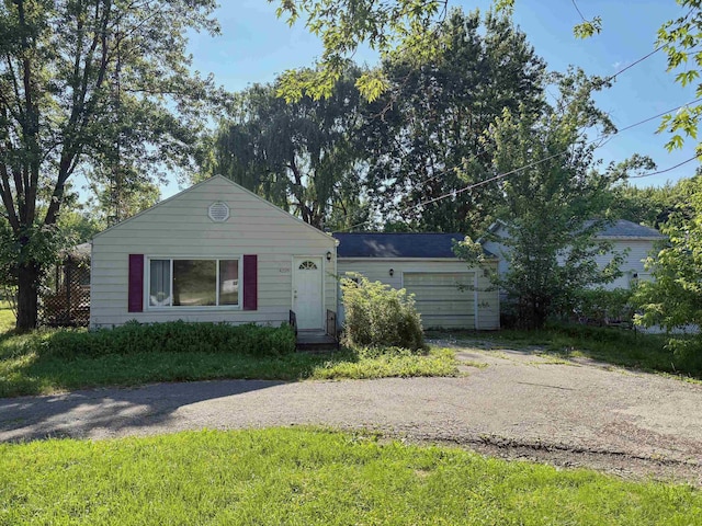 4299 N Belsay Rd, Flint, MI 48506 - view of front of home with a garage and asphalt driveway