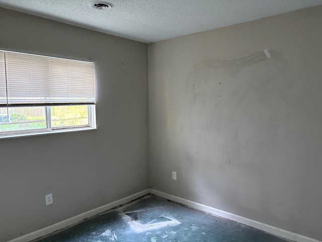 4299 N Belsay Rd, Flint, MI 48506 - unfurnished room with baseboards and a textured ceiling