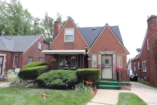 3685 W Outer Dr, Detroit, MI 48221 - view of front of home with a chimney, brick siding, and a shingled roof