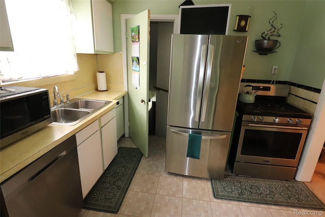 3685 W Outer Dr, Detroit, MI 48221 - kitchen featuring stainless steel appliances, white cabinetry, light countertops, and light tile patterned floors