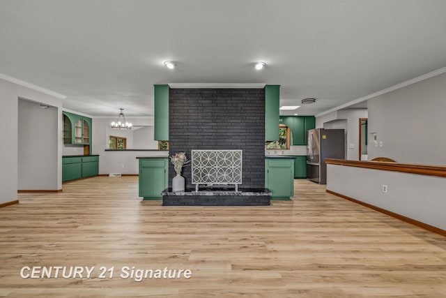 9 Wiltse Ct, Saginaw, MI 48603 - unfurnished living room featuring ornamental molding, light wood finished floors, a chandelier, and a brick fireplace