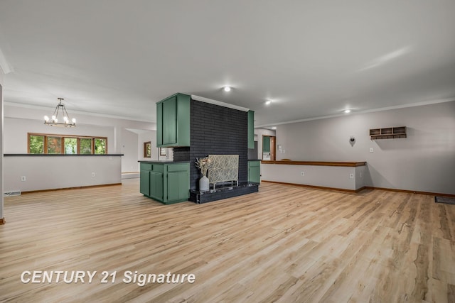 9 Wiltse Ct, Saginaw, MI 48603 - unfurnished living room featuring ornamental molding, a chandelier, light wood finished floors, and a brick fireplace