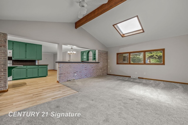 9 Wiltse Ct, Saginaw, MI 48603 - unfurnished living room featuring light colored carpet, a skylight, a chandelier, and brick wall