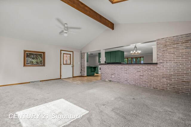 9 Wiltse Ct, Saginaw, MI 48603 - unfurnished living room featuring carpet floors, a ceiling fan, a chandelier, brick wall, and plenty of natural light