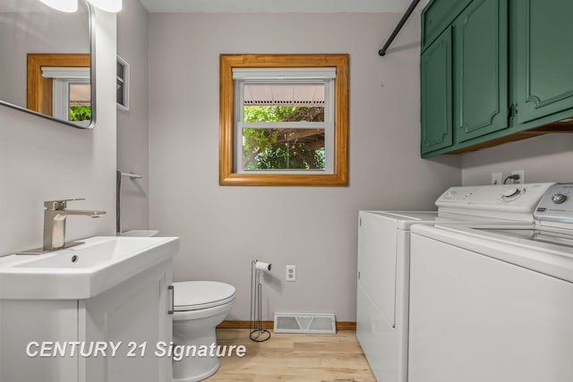 9 Wiltse Ct, Saginaw, MI 48603 - half bath with washing machine and clothes dryer, wood finished floors, and vanity