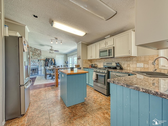 8955 Grafton Rd, Newport, MI 48166 - kitchen featuring stainless steel appliances, wood counters, a textured ceiling, crown molding, and a kitchen island