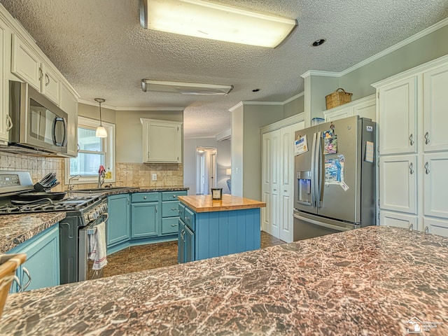 8955 Grafton Rd, Newport, MI 48166 - kitchen featuring stainless steel appliances, butcher block counters, a textured ceiling, backsplash, and crown molding