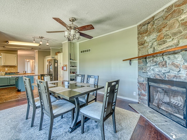 8955 Grafton Rd, Newport, MI 48166 - dining room with ceiling fan, a textured ceiling, ornamental molding, and dark wood-style floors