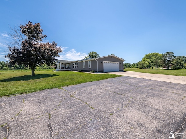 8955 Grafton Rd, Newport, MI 48166 - ranch-style home with a front yard, a garage, and driveway