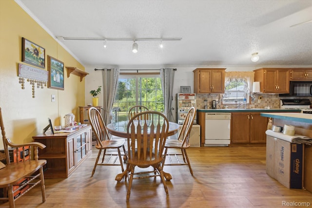 4591 Swaffer Rd, Millington, MI 48746 - dining room with light wood finished floors, rail lighting, and crown molding