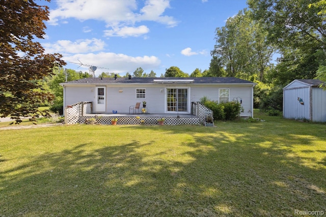 4591 Swaffer Rd, Millington, MI 48746 - back of property featuring a storage unit, a lawn, and a deck