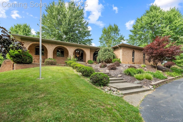 945 E Gunn Rd, Rochester, MI 48306 - view of front of home featuring brick siding and a front lawn