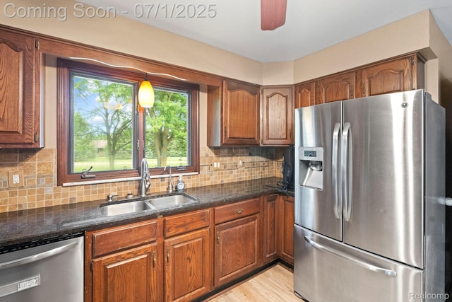 945 E Gunn Rd, Rochester, MI 48306 - kitchen featuring stainless steel appliances, brown cabinetry, and decorative backsplash