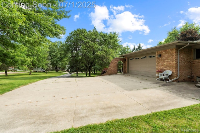945 E Gunn Rd, Rochester, MI 48306 - view of side of property featuring brick siding, concrete driveway, a garage, and a yard