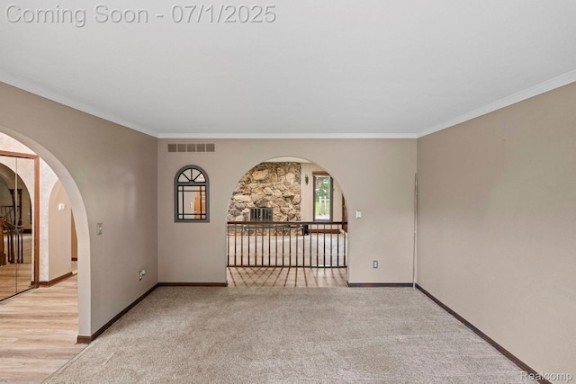 945 E Gunn Rd, Rochester, MI 48306 - carpeted empty room featuring ornamental molding and arched walkways