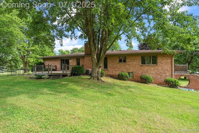 945 E Gunn Rd, Rochester, MI 48306 - back of property featuring brick siding, a wooden deck, and a chimney